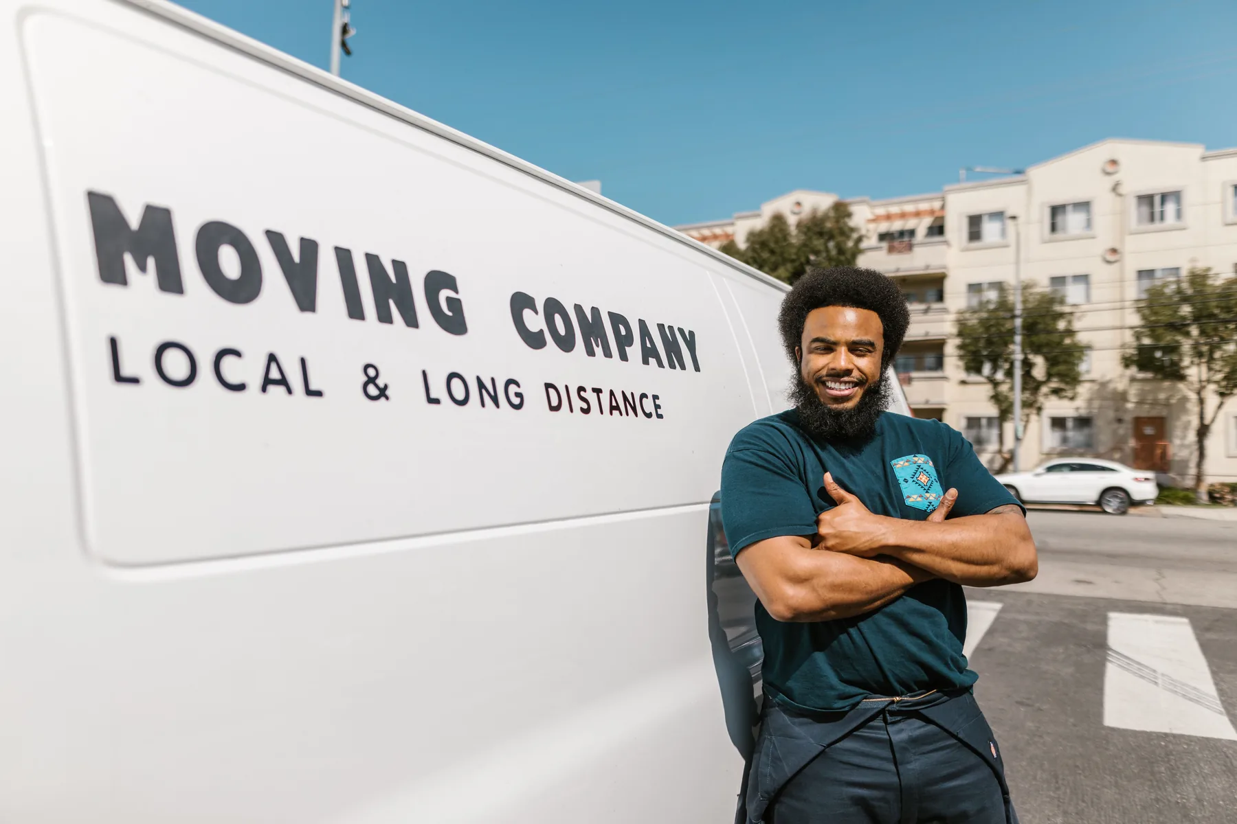 Professional mover standing beside moving vehicle
