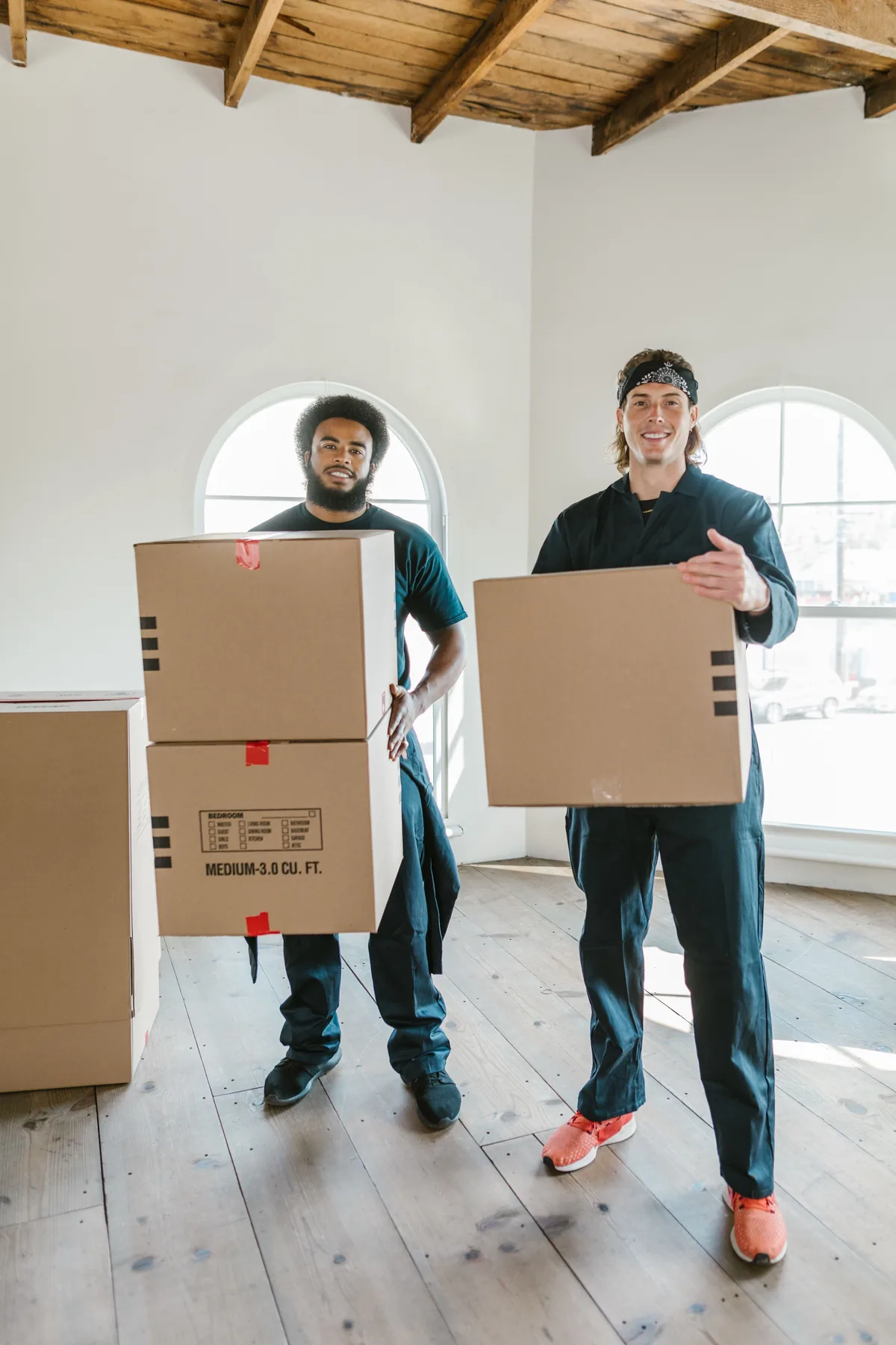 Movers carrying boxes indoors