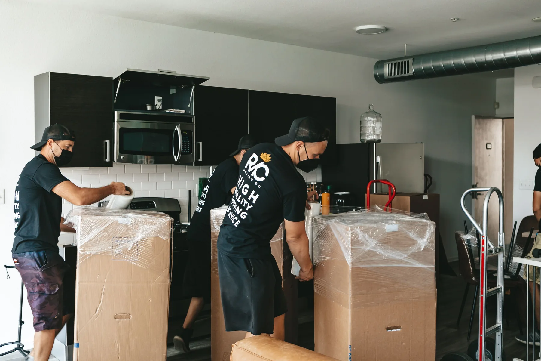 Moving team packing furniture carefully